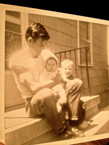 Daddy in his 20's holding baby Sherri with toddler Billy Dean next to him.